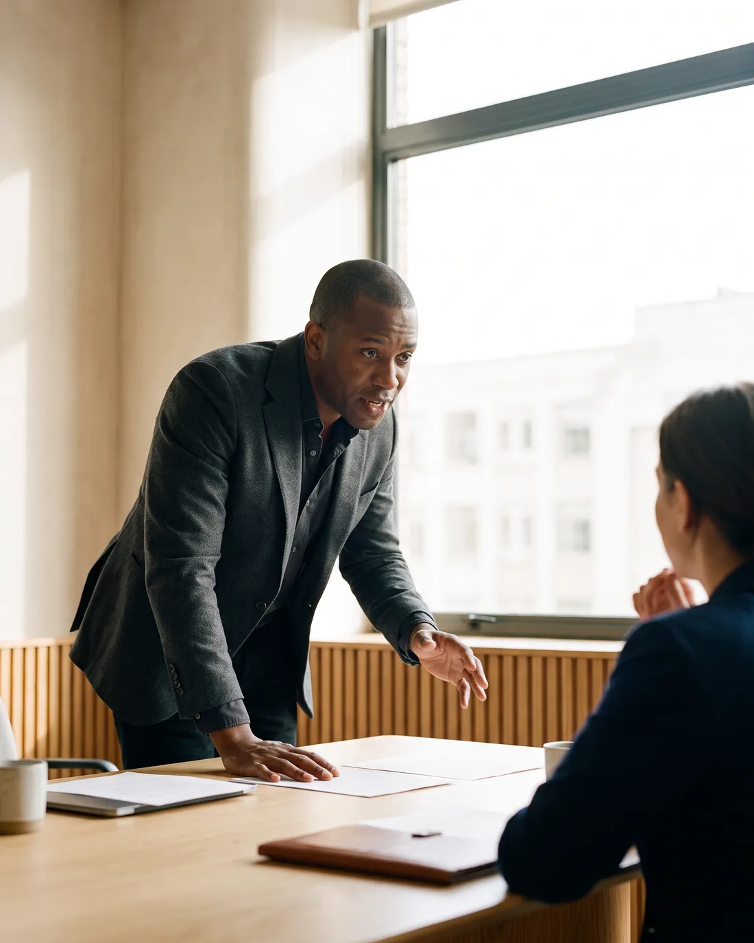 A senior CFO reviewing the work in a calm Geneva boardroom